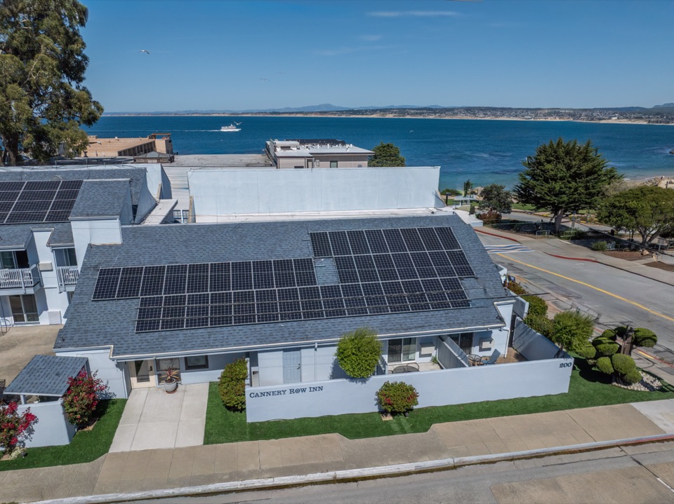 Aerial view of Cannery Row Inn with Monterey Bay and the beach beyond