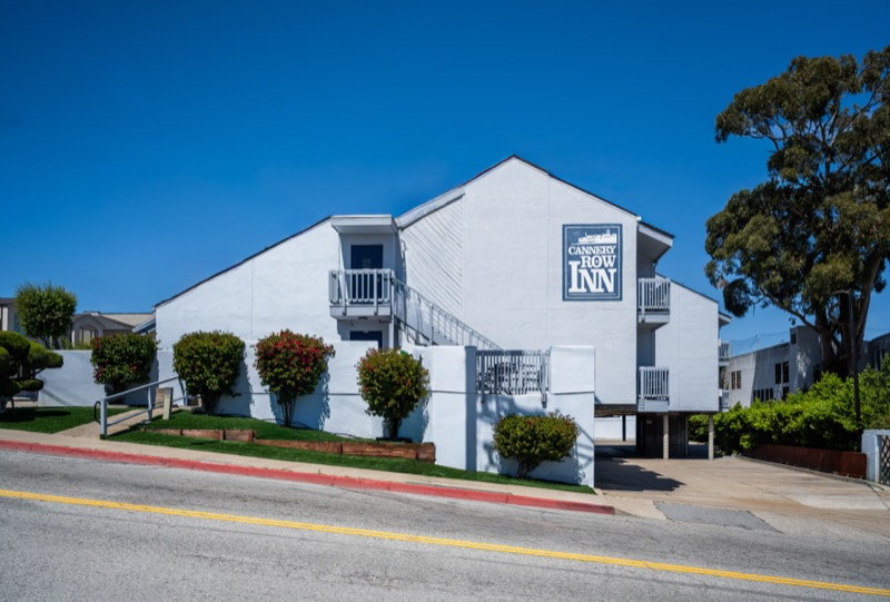Street corner view of the inn with painted logo and balconies