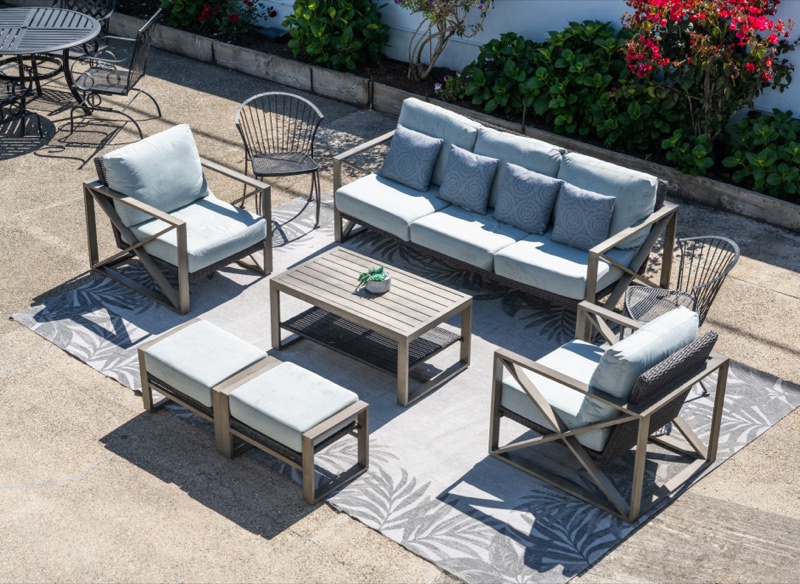 The garden courtyard lounge with sofas, ottomans, and a flowering border