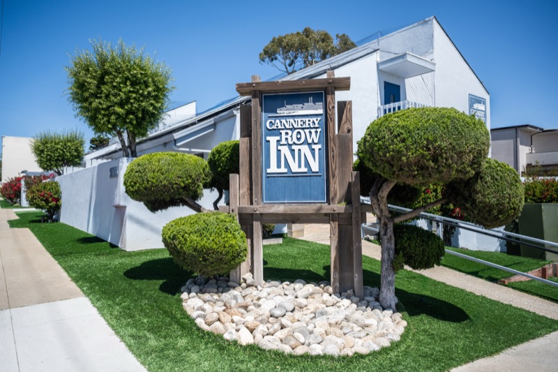 Daylight view of the entrance sign and topiary garden
