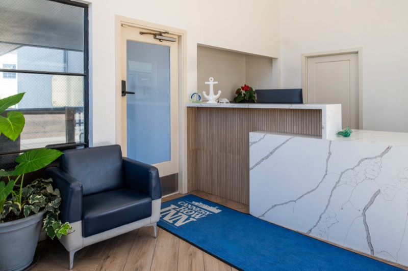 Front desk with white quartz counter and navy armchair