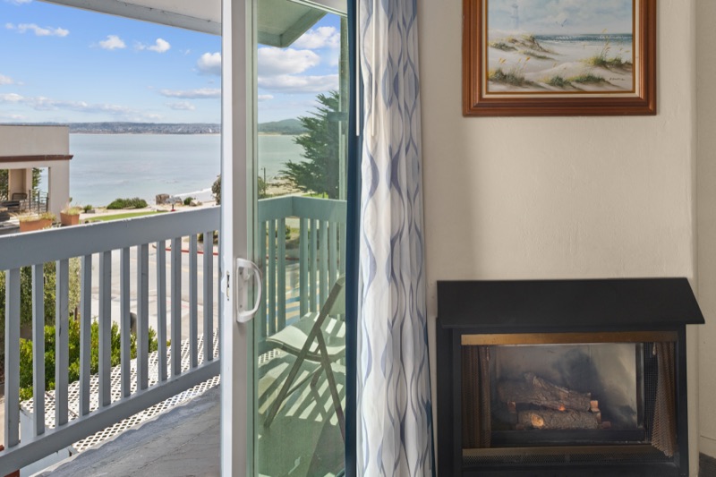 Sliding door open to a balcony overlooking Monterey Bay