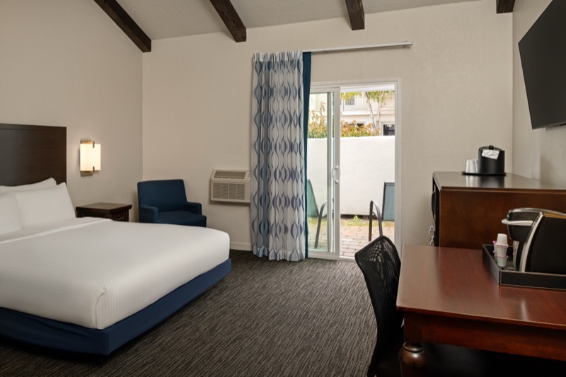 Accessible queen room with beamed ceiling and step-free patio access